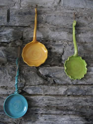 Oversized serving spoon adaptable for hanging once done using them